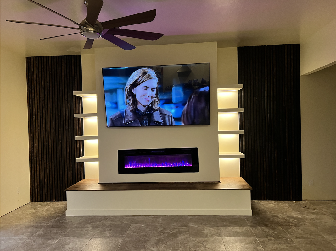 Living Room Media Center with the TV Mounted, Electric Fireplace, Shelves with lighting, Wood Slats with a hidden door in Phoenix, AZ